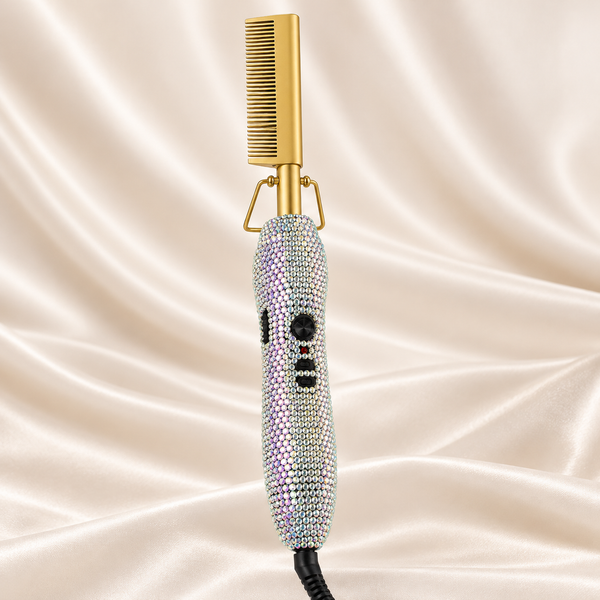 Silver AB rhinestone electric hot comb with gold head on cream satin