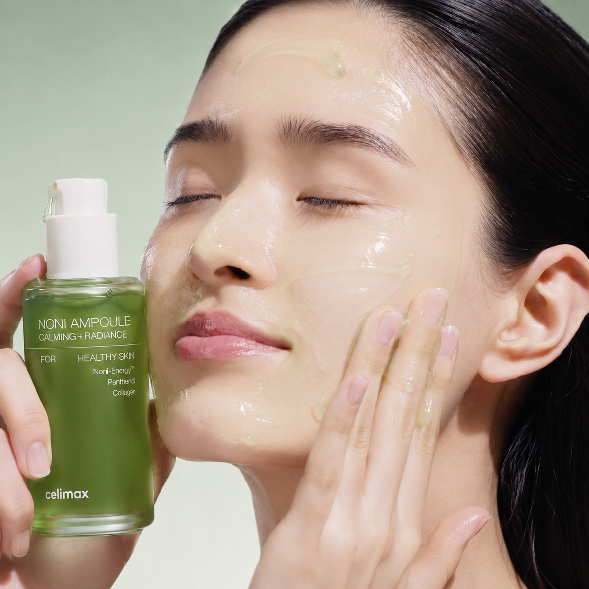 Woman applying Celimax The Real Noni Energy Ampoule to her face