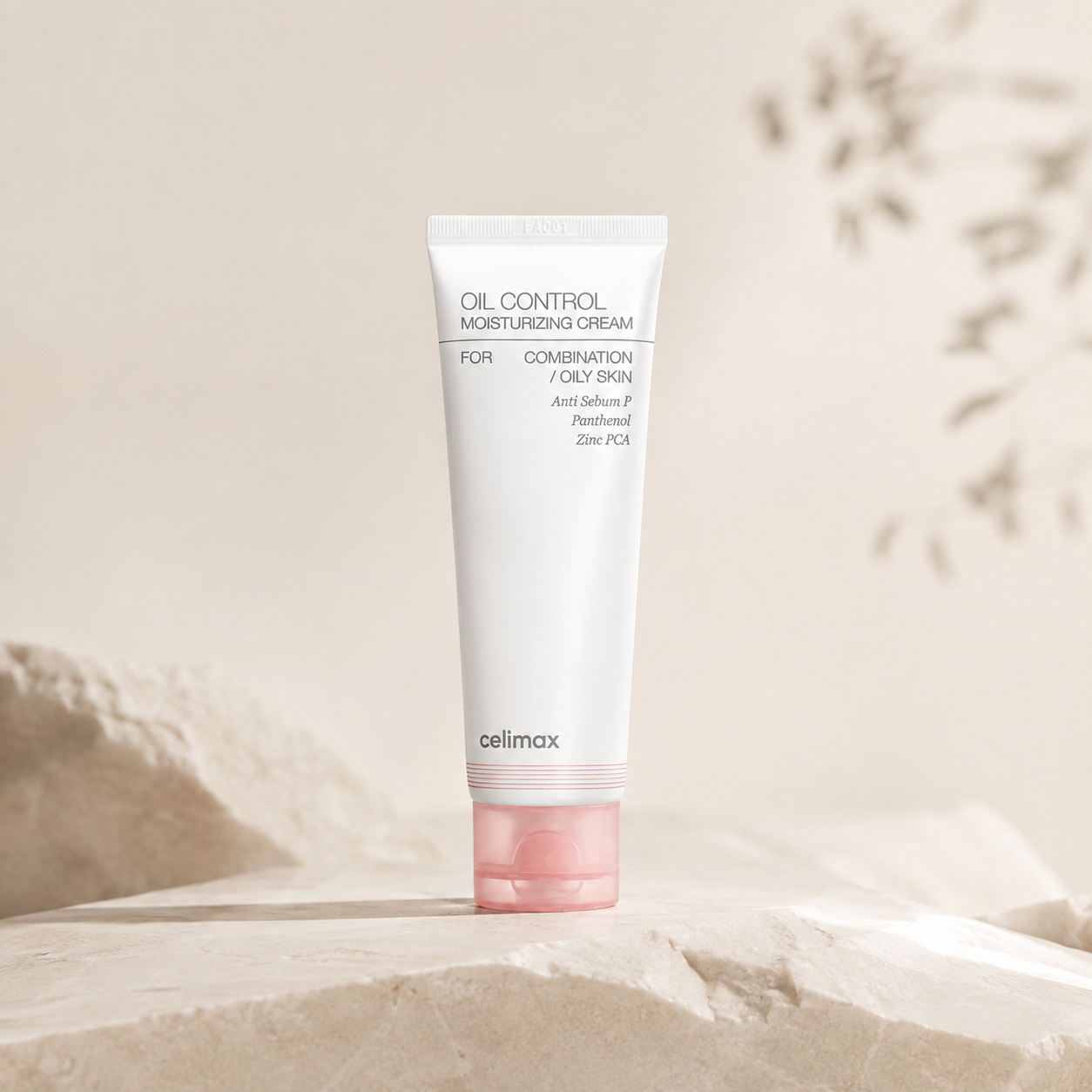 Celimax Oil Control Moisturizing Cream tube on a stone backdrop, formulated with an Anti Sebum P and Anti Pore S complex