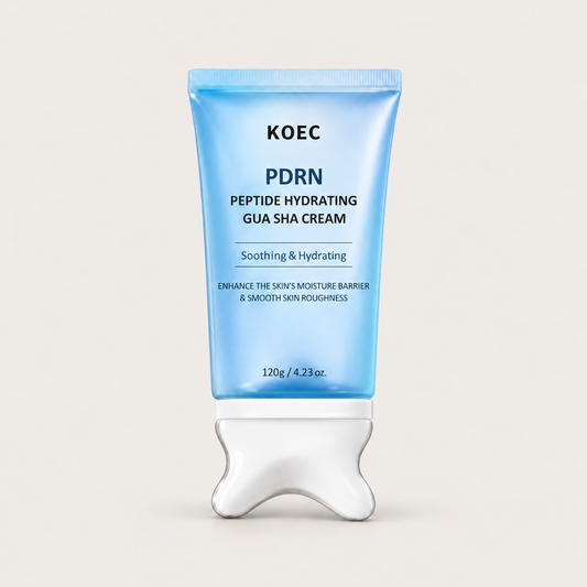 Blue KOEC PDRN Peptide Hydrating Gua Sha Cream 120g tube with a silver-white built-in applicator on an ivory background