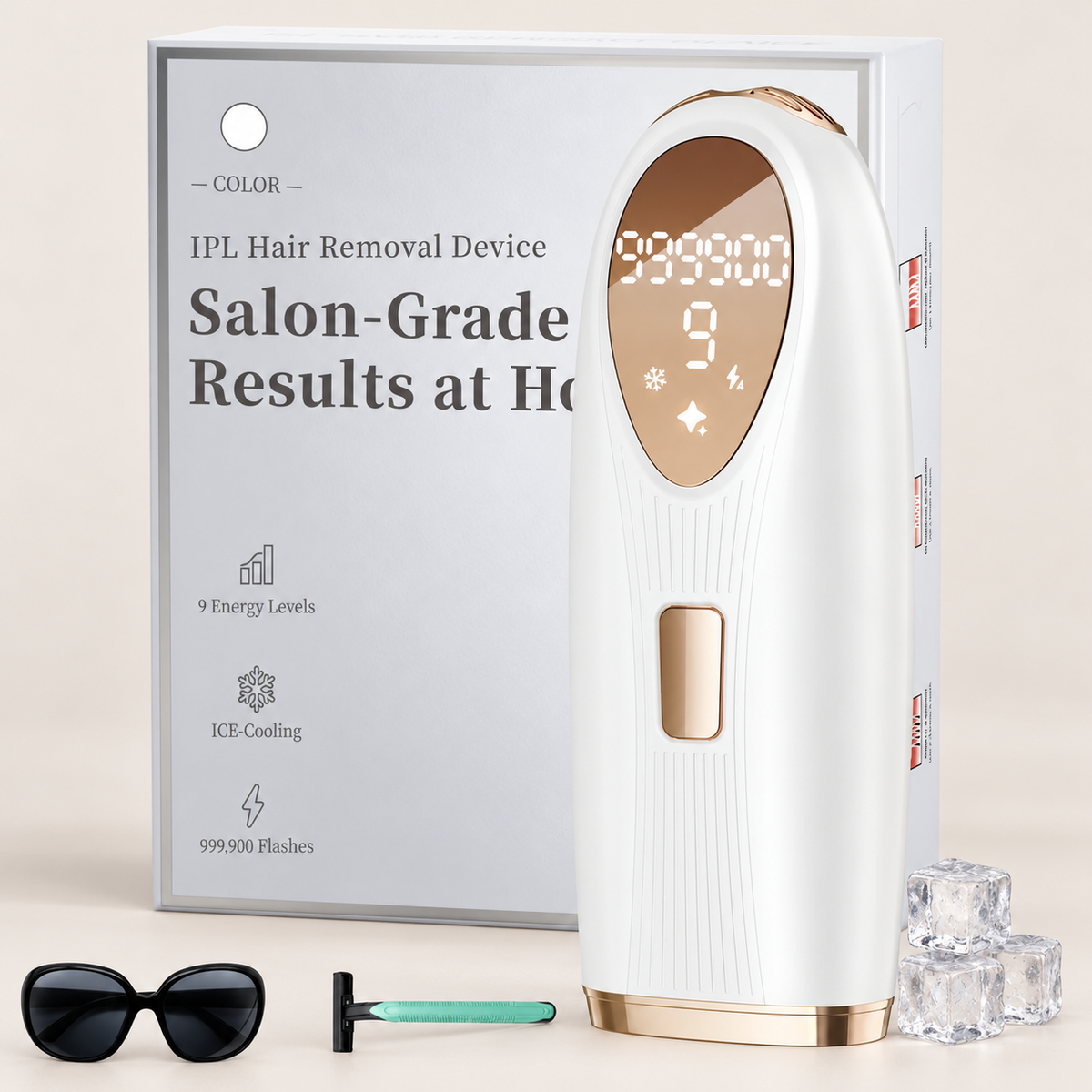 White and champagne-gold IPL device with packaging, eyewear, razor and three decorative ice cubes on beige