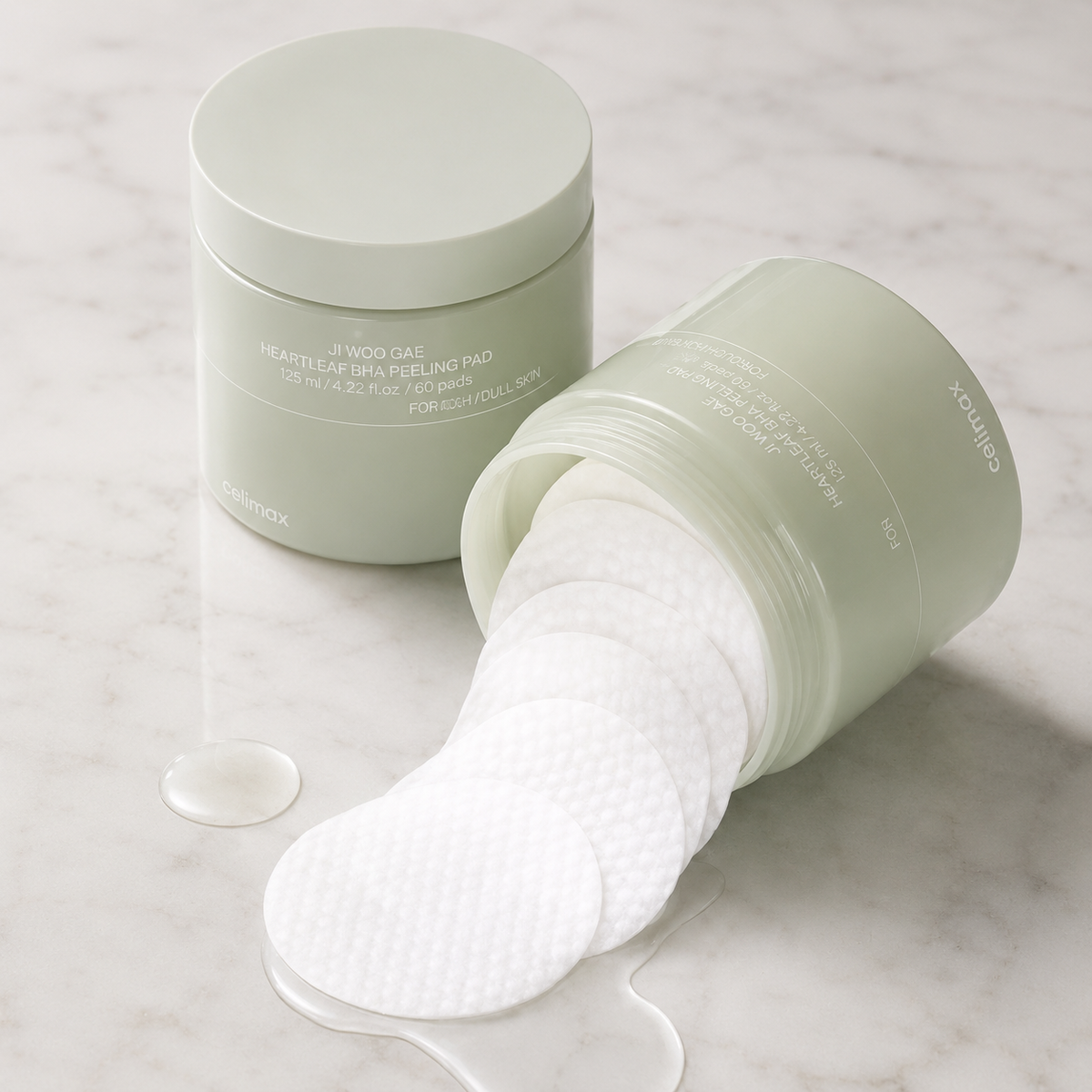 Ji Woo Gae Heartleaf BHA Peeling Pad jar with pads spilling out onto marble