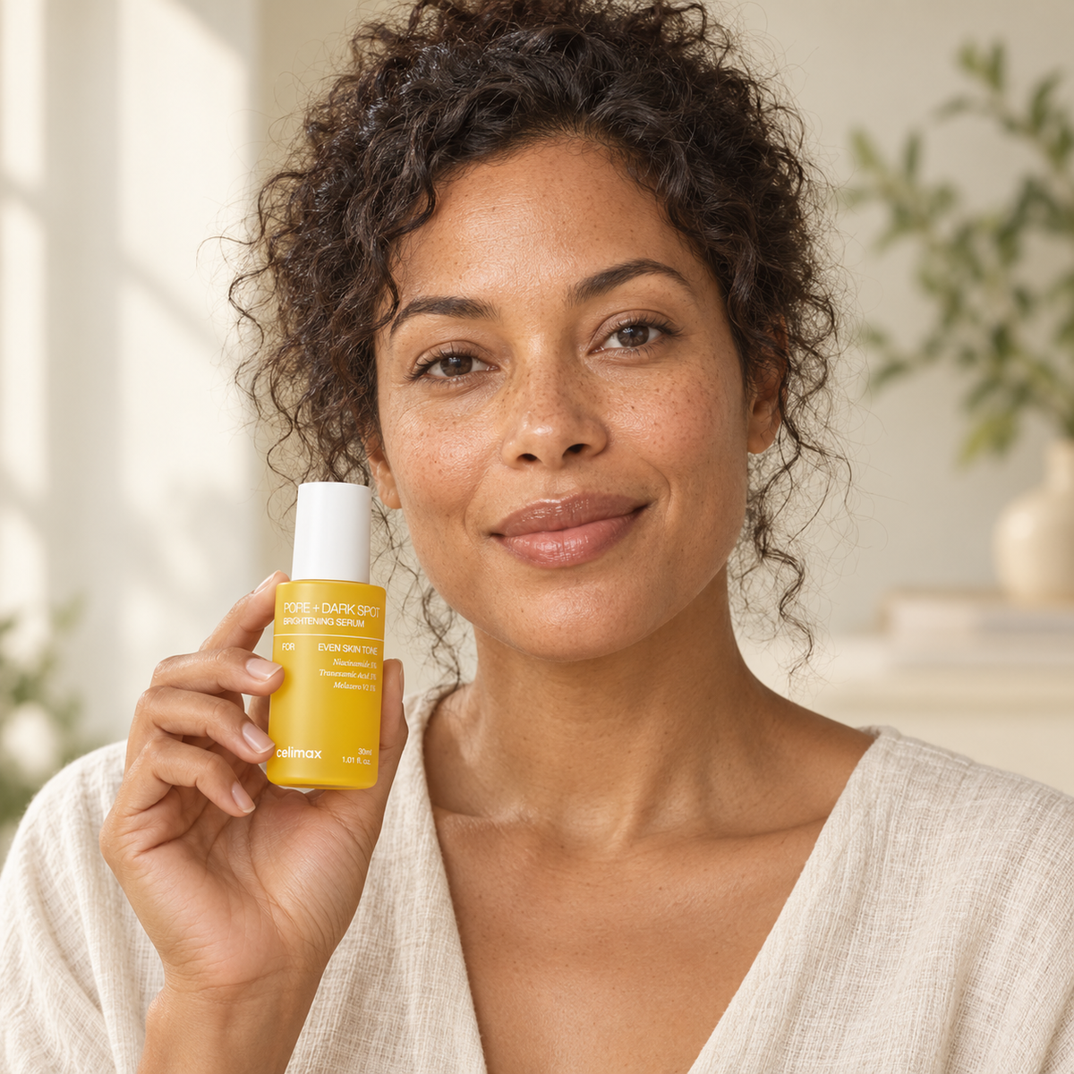 Model holding Celimax Pore + Dark Spot Brightening Serum, illustrative lifestyle image
