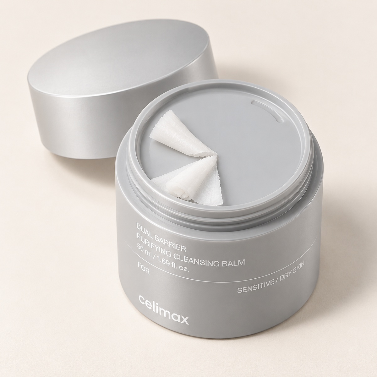 Celimax cleansing balm grinder jar opened to show the dispensing plate and white balm ribbons