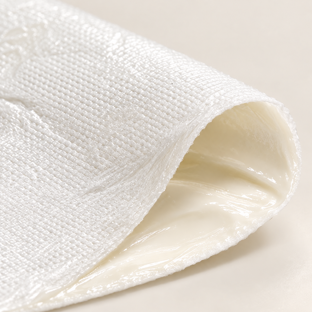 Illustration of the cream-coated surface of a white sheet mask