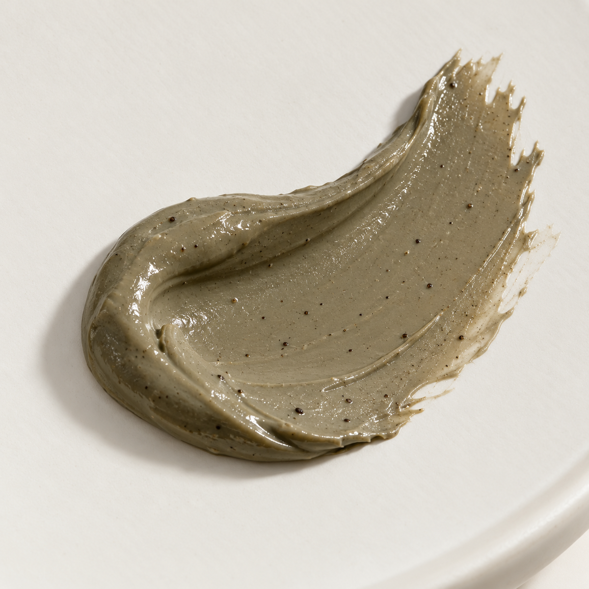 Illustrative close-up of the Noni clay mask's creamy olive-gray texture