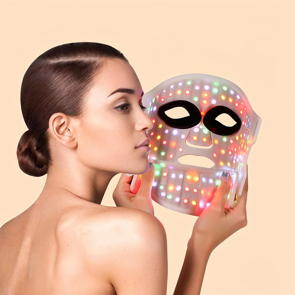 7-color LED light therapy face mask shown in all light modes, soft studio lighting