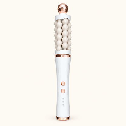 White 3D Wave rotating facial massager with cream fluted rollers and rose-gold-toned accents