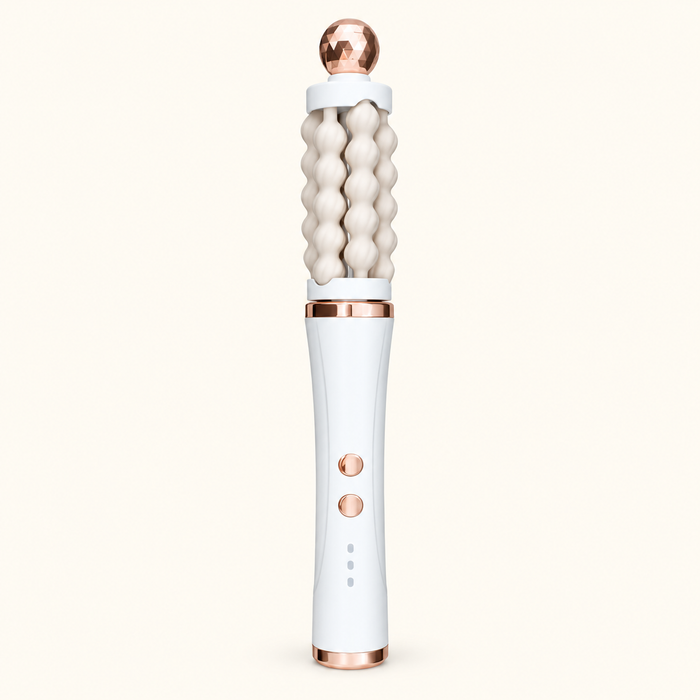 White 3D Wave rotating facial massager with cream fluted rollers and rose-gold-toned accents