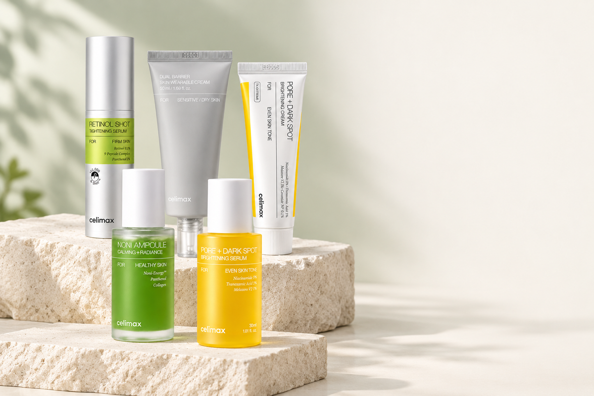 Celimax Retinol Shot Serum, Dual Barrier Cream, Dark Spot Cream, Noni Ampoule and Dark Spot Serum arranged on pale stone