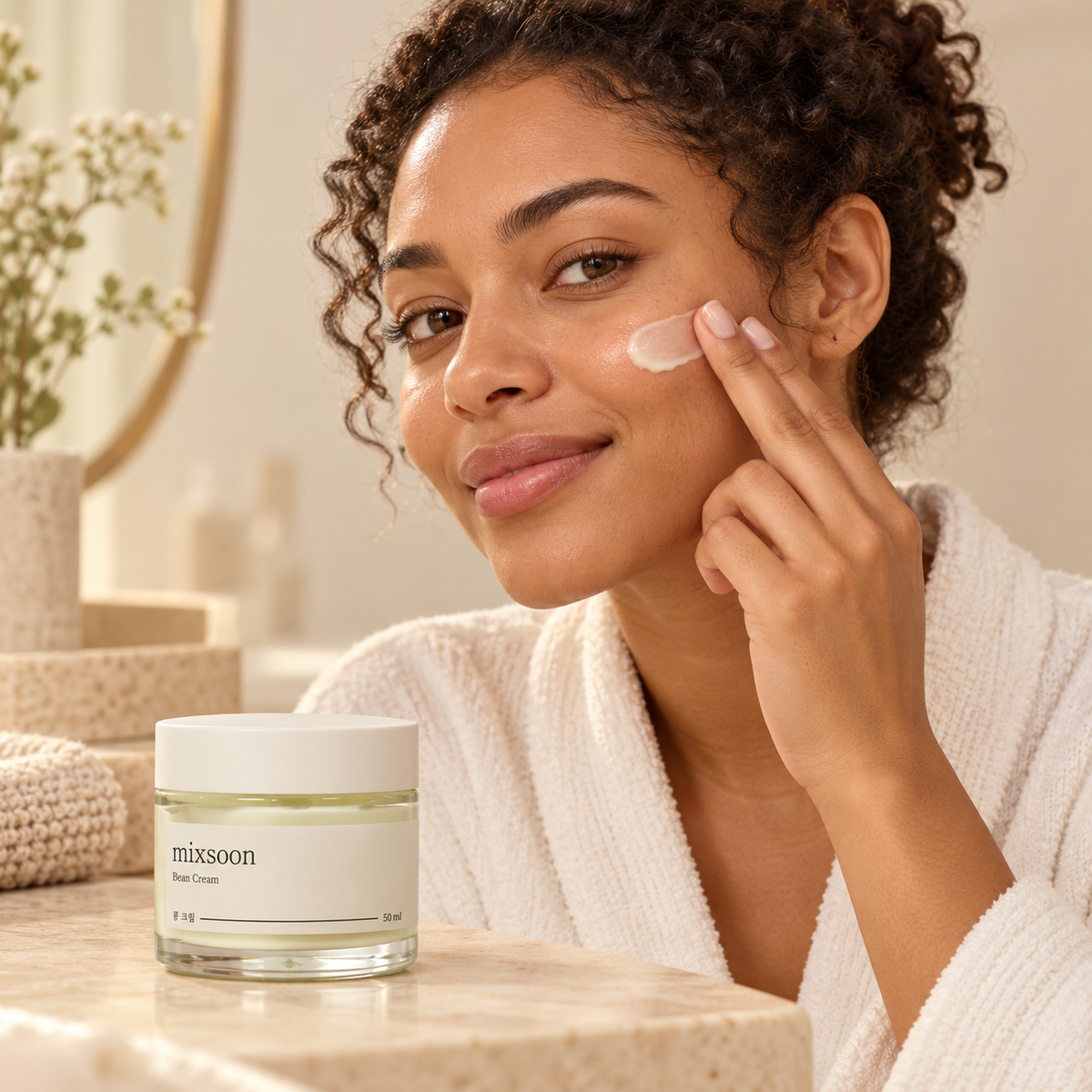 Illustration of gently smoothing moisturizer onto the cheek with Mixsoon Bean Cream nearby