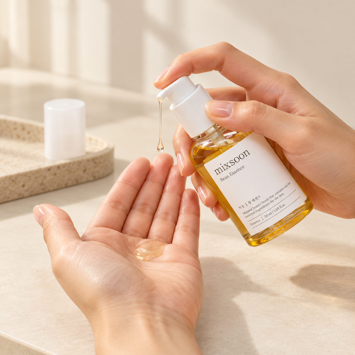 Dispensing a small dose of mixsoon Bean Essence into an open palm